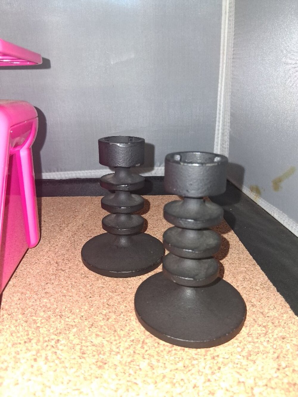 TWO VINTAGE MATT BLACK ENAMELED CAST IRON 'HOBART' CANDLESTICKS